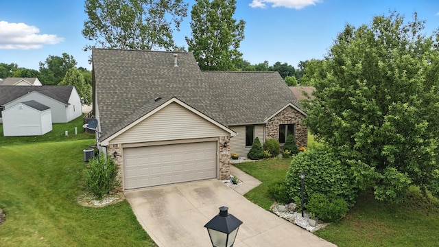 5130 Windy Knoll Ct, Fort Wayne, IN 46809 - view of front of property featuring driveway, a front yard, a shingled roof, a garage, and stone siding