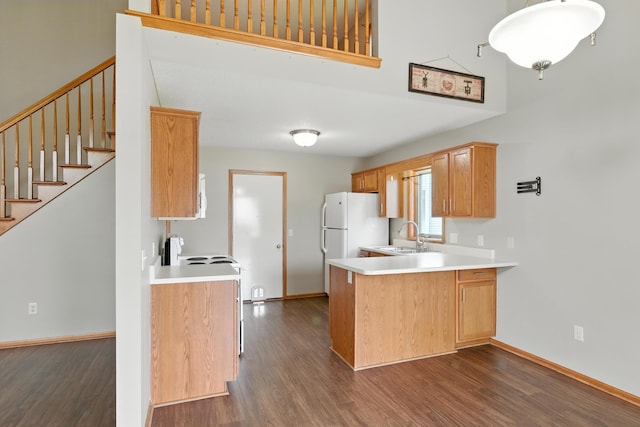 5130 Windy Knoll Ct, Fort Wayne, IN 46809 - kitchen with dark wood-style flooring, a peninsula, light countertops, and freestanding refrigerator