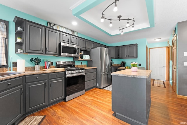 11301 Clarendon Pass, Fort Wayne, IN 46845 - kitchen with stainless steel appliances, open shelves, a kitchen island, light wood finished floors, and light countertops