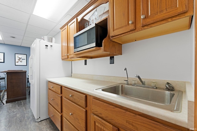 11301 Clarendon Pass, Fort Wayne, IN 46845 - kitchen featuring wood finished floors, stainless steel microwave, light countertops, freestanding refrigerator, and brown cabinetry