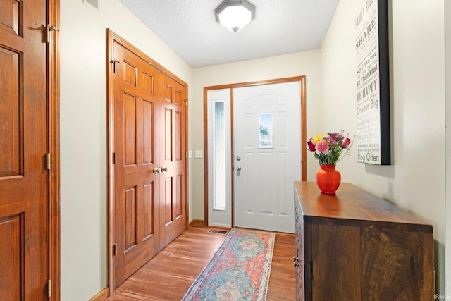 11301 Clarendon Pass, Fort Wayne, IN 46845 - foyer with light wood-type flooring and a textured ceiling