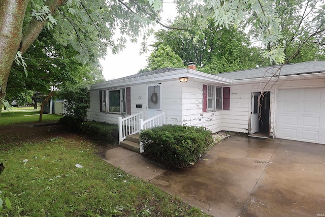 310 W Elm St, Millersburg, IN 46543 - single story home with an attached garage, driveway, a chimney, and roof with shingles