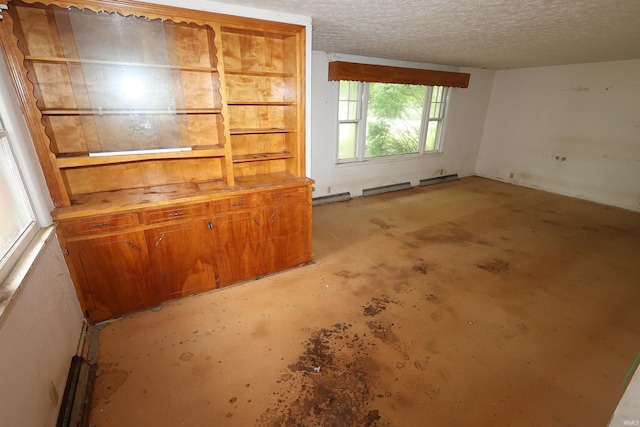 310 W Elm St, Millersburg, IN 46543 - unfurnished living room with concrete floors and a textured ceiling