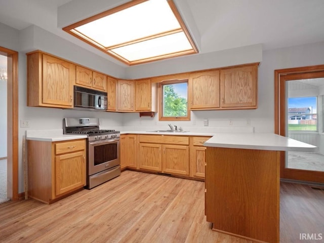624 Diamond Point Pl, Fort Wayne, IN 46804 - kitchen featuring black microwave, stainless steel range with gas cooktop, a peninsula, and light wood finished floors
