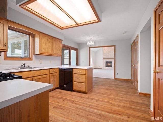 624 Diamond Point Pl, Fort Wayne, IN 46804 - kitchen with black dishwasher, a peninsula, a chandelier, and light countertops