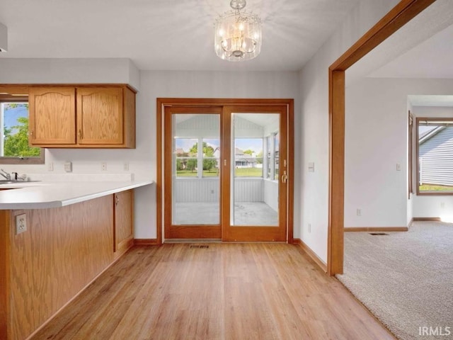 624 Diamond Point Pl, Fort Wayne, IN 46804 - entryway featuring plenty of natural light, light wood-type flooring, and a chandelier
