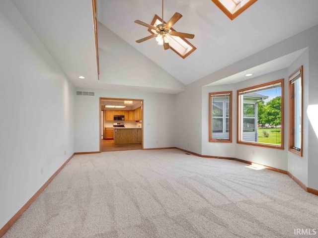 624 Diamond Point Pl, Fort Wayne, IN 46804 - unfurnished living room featuring a skylight, light colored carpet, lofted ceiling, ceiling fan, and recessed lighting