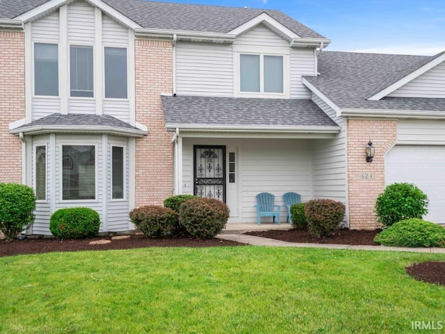 624 Diamond Point Pl, Fort Wayne, IN 46804 - traditional-style home featuring roof with shingles, a front lawn, a garage, and brick siding