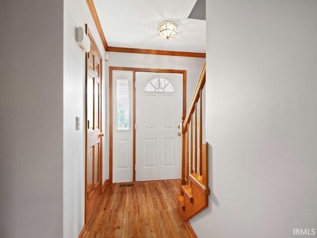 624 Diamond Point Pl, Fort Wayne, IN 46804 - foyer entrance with light wood-style floors, crown molding, and stairway