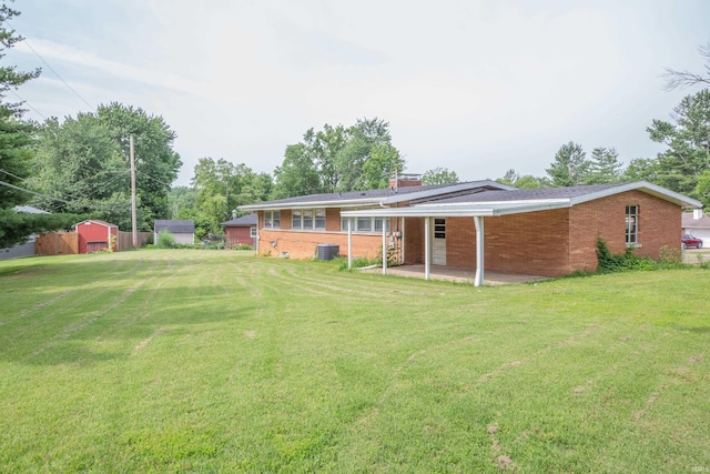 7811 Meadowview Dr, Evansville, IN 47710 - back of house with brick siding, a lawn, and a patio