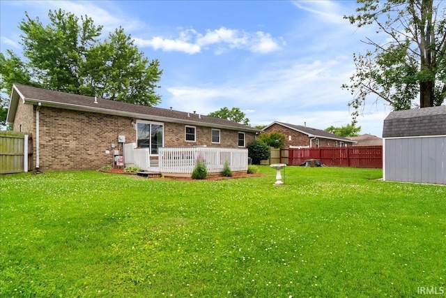 8766 Arcadia Dr, Newburgh, IN 47630 - rear view of house featuring a fenced backyard, a wooden deck, a storage unit, and brick siding