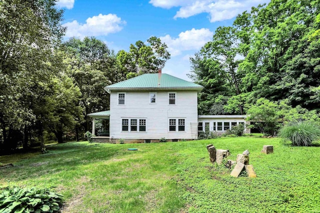 9730 N Moon Rd, Gosport, IN 47433 - rear view of house featuring a yard, a metal roof, and a chimney
