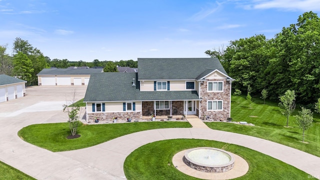 17818 Amstutz Rd, Leo, IN 46765 - traditional-style home with stone siding, curved driveway, a front lawn, and a porch