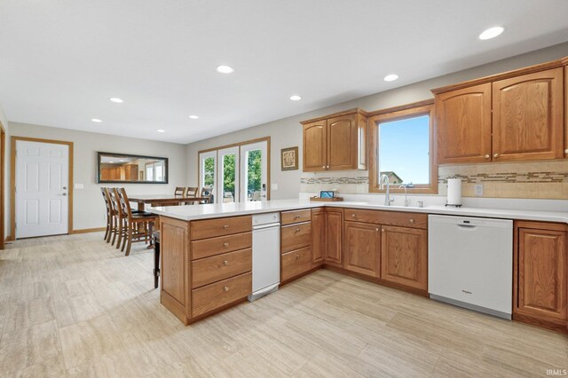 17818 Amstutz Rd, Leo, IN 46765 - kitchen with dishwasher, a peninsula, light countertops, recessed lighting, and brown cabinets