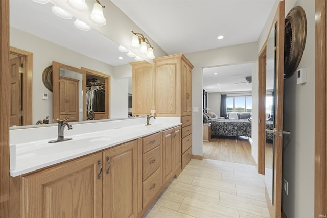 17818 Amstutz Rd, Leo, IN 46765 - ensuite bathroom featuring double vanity, recessed lighting, ceiling fan, and a spacious closet