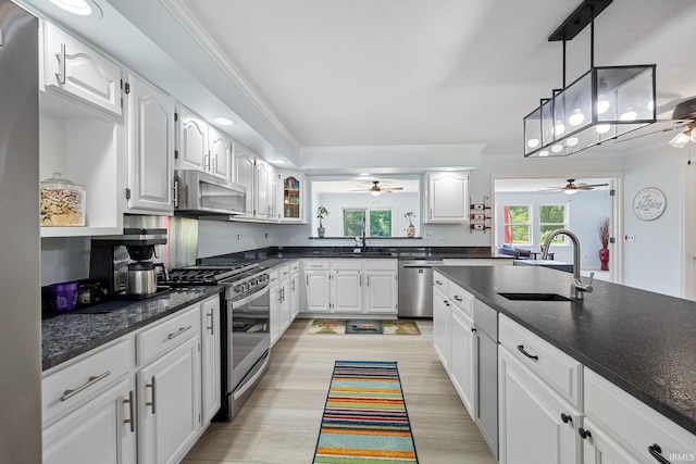 2131 E 430 Rd S, Lafayette, IN 47909 - kitchen with appliances with stainless steel finishes, ceiling fan, crown molding, white cabinetry, and dark stone counters