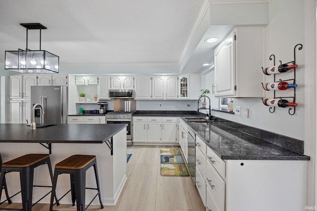 2131 E 430 Rd S, Lafayette, IN 47909 - kitchen featuring appliances with stainless steel finishes, a kitchen bar, light wood-style floors, white cabinets, and recessed lighting