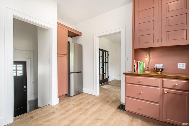 507 W Marion St, South Bend, IN 46601 - kitchen featuring freestanding refrigerator, light wood finished floors, and dark countertops