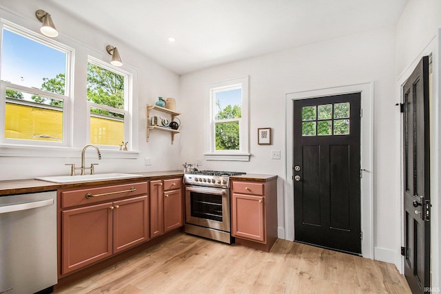 507 W Marion St, South Bend, IN 46601 - kitchen featuring appliances with stainless steel finishes, light wood-style flooring, and brown cabinetry