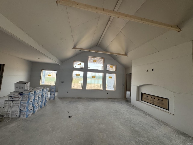 9942 Gala Cv, Fort Wayne, IN 46835 - unfurnished living room featuring vaulted ceiling, concrete floors, and a fireplace
