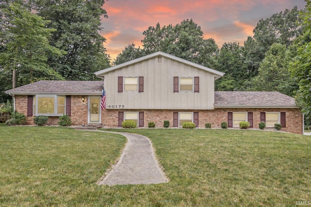 60175 Emerald Dr, South Bend, IN 46614 - split level home featuring brick siding, a yard, and roof with shingles