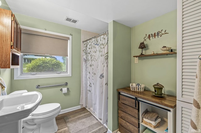 60175 Emerald Dr, South Bend, IN 46614 - full bathroom with wood finished floors and a shower with shower curtain