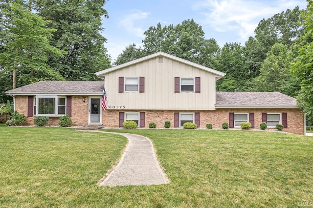 60175 Emerald Dr, South Bend, IN 46614 - split level home with brick siding, a front yard, and a shingled roof