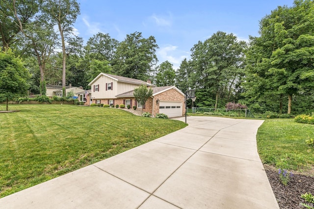 60175 Emerald Dr, South Bend, IN 46614 - view of home's exterior featuring brick siding, concrete driveway, an attached garage, view of wooded area, and a chimney