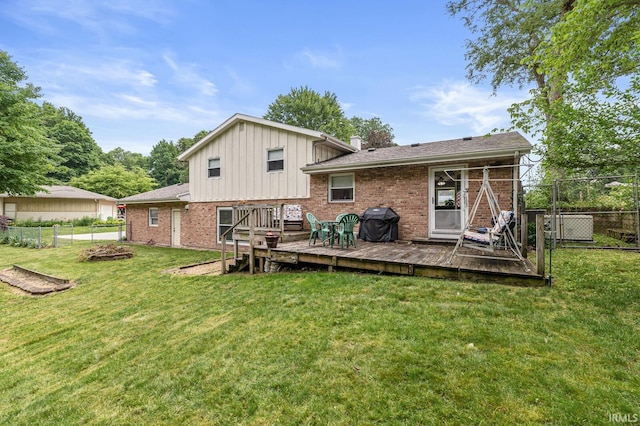 60175 Emerald Dr, South Bend, IN 46614 - rear view of property with a fenced backyard, a deck, brick siding, and a gate