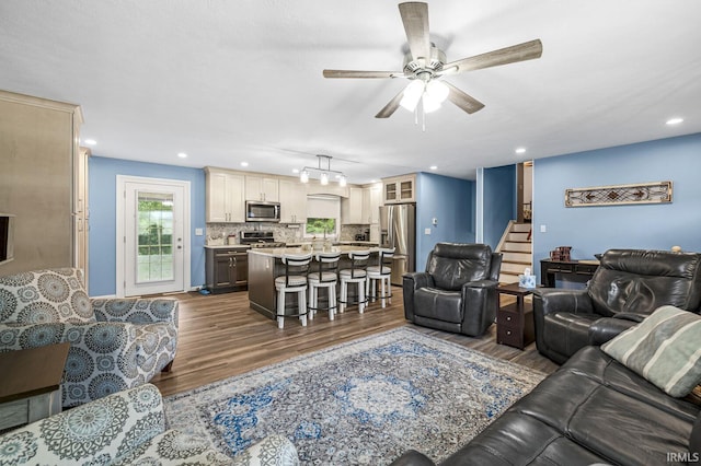 60175 Emerald Dr, South Bend, IN 46614 - living room featuring stairs, dark wood-style flooring, a ceiling fan, and recessed lighting