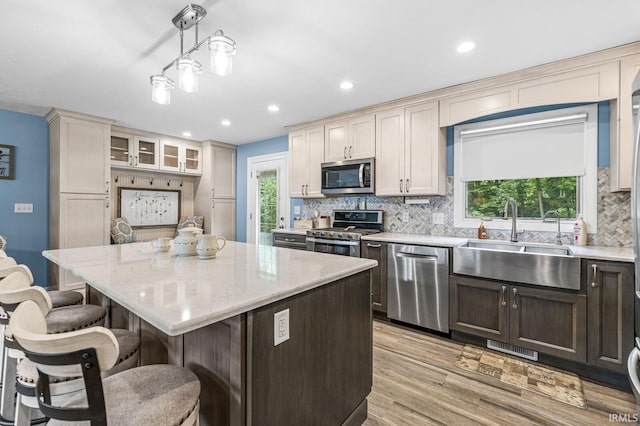 60175 Emerald Dr, South Bend, IN 46614 - kitchen with stainless steel appliances, a kitchen bar, backsplash, a kitchen island, and recessed lighting