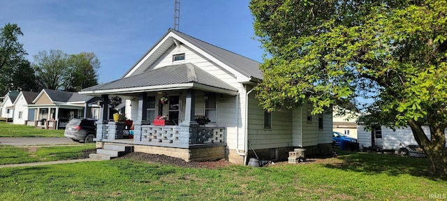 601 N State Road 57, Washington, IN 47501 - bungalow-style house with a porch, a front yard, and a metal roof