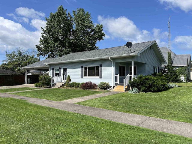 89 NE H St, Linton, IN 47441 - single story home featuring a front lawn, a carport, driveway, and roof with shingles