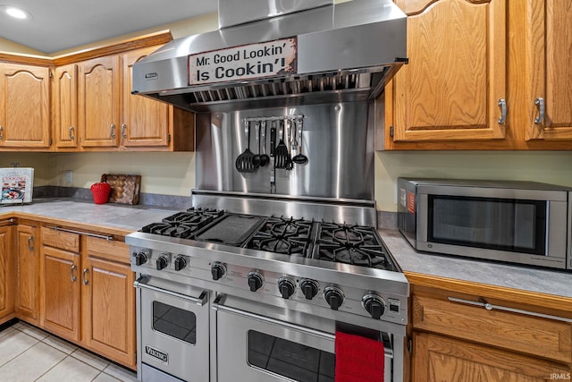 2166 Willow Creek Dr, Mishawaka, IN 46545 - kitchen with appliances with stainless steel finishes, light countertops, wall chimney exhaust hood, light tile patterned floors, and brown cabinetry