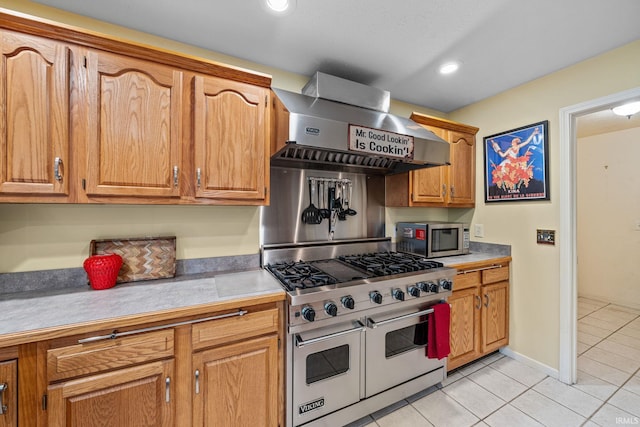 2166 Willow Creek Dr, Mishawaka, IN 46545 - kitchen featuring appliances with stainless steel finishes, wall chimney range hood, light tile patterned flooring, light countertops, and brown cabinets