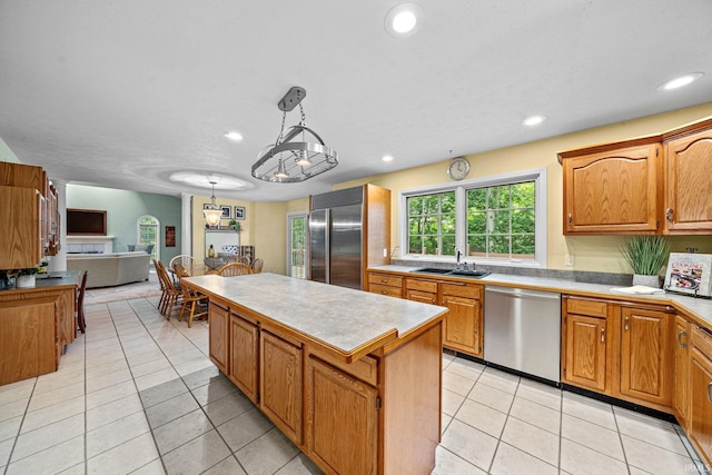 2166 Willow Creek Dr, Mishawaka, IN 46545 - kitchen with appliances with stainless steel finishes, a kitchen island, open floor plan, light tile patterned flooring, and light countertops
