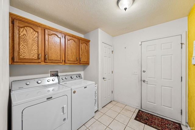 2166 Willow Creek Dr, Mishawaka, IN 46545 - laundry area featuring cabinet space, separate washer and dryer, a textured ceiling, and light tile patterned flooring