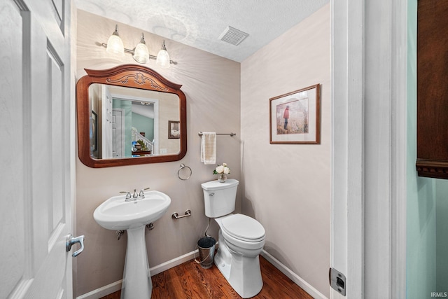2166 Willow Creek Dr, Mishawaka, IN 46545 - half bathroom featuring wood finished floors and a textured ceiling