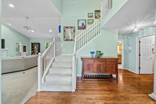 2166 Willow Creek Dr, Mishawaka, IN 46545 - staircase featuring a ceiling fan, wood finished floors, high vaulted ceiling, and recessed lighting
