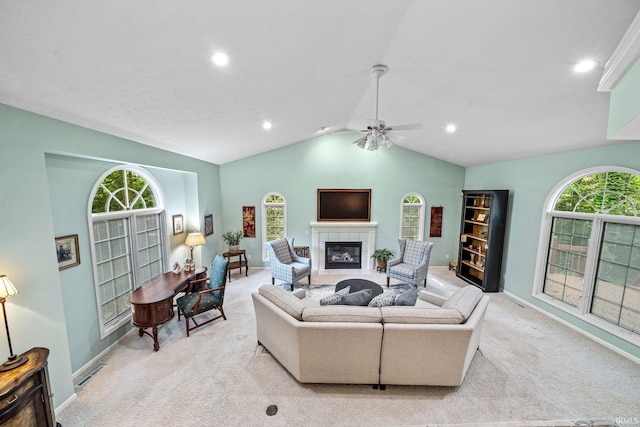 2166 Willow Creek Dr, Mishawaka, IN 46545 - living room with light carpet, a tile fireplace, ceiling fan, lofted ceiling, and recessed lighting
