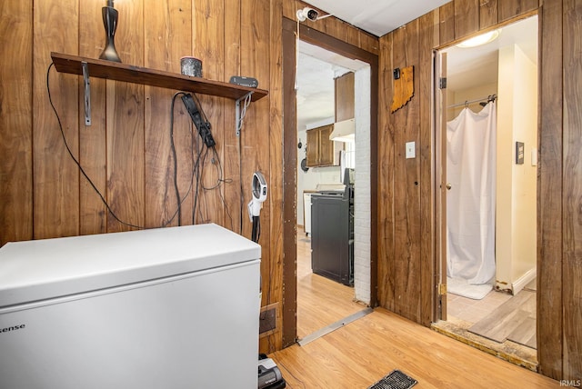 227 E Marion St, Mishawaka, IN 46545 - laundry room featuring light wood-style floors and wooden walls