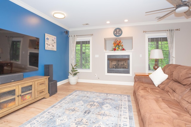 6488 Pebble Pointe Ct, Newburgh, IN 47630 - living room featuring a fireplace, a ceiling fan, light wood-style floors, and crown molding