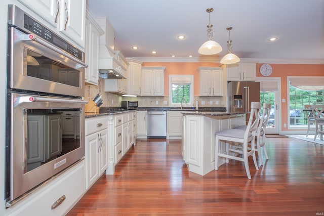 6488 Pebble Pointe Ct, Newburgh, IN 47630 - kitchen featuring appliances with stainless steel finishes, crown molding, a breakfast bar, decorative backsplash, and pendant lighting
