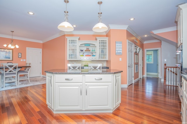 6488 Pebble Pointe Ct, Newburgh, IN 47630 - kitchen with light wood finished floors, a chandelier, white cabinets, glass insert cabinets, and ornamental molding