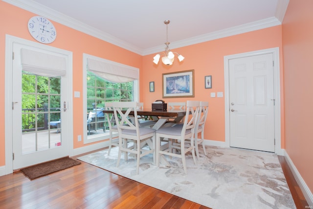 6488 Pebble Pointe Ct, Newburgh, IN 47630 - dining space with ornamental molding, a chandelier, and wood finished floors