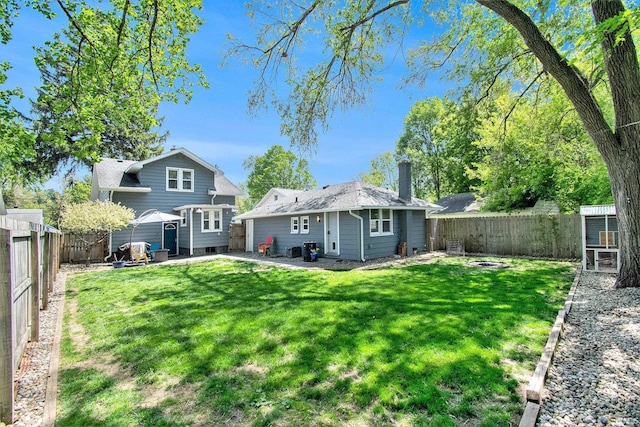 909 Independence St, Elkhart, IN 46514 - back of property with a chimney and a fenced backyard