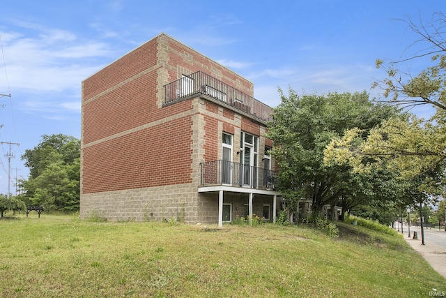 820 N Niles Ave Unit C, South Bend, IN 46617 - view of property exterior with a balcony, brick siding, and a yard