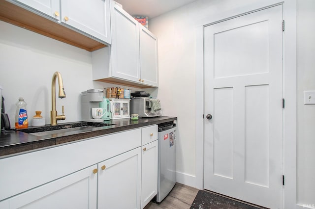 820 N Niles Ave Unit C, South Bend, IN 46617 - kitchen with light wood finished floors, white cabinets, and dark countertops