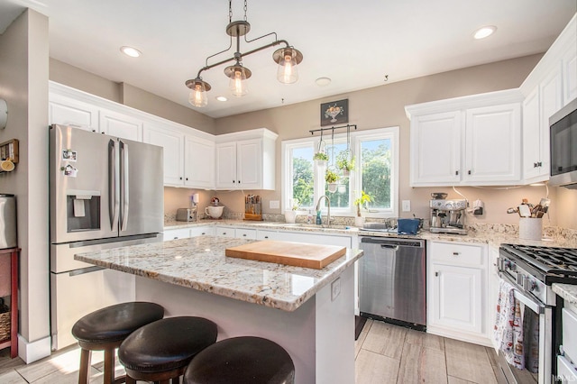 820 N Niles Ave Unit C, South Bend, IN 46617 - kitchen featuring stainless steel appliances, white cabinetry, a center island, light stone counters, and recessed lighting