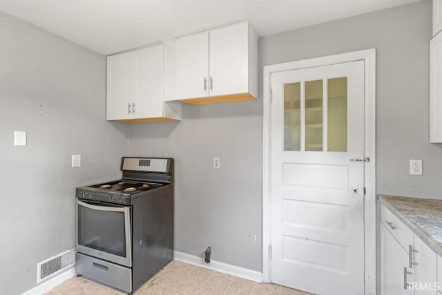 414 Klinger Ave, Plymouth, IN 46563 - kitchen featuring stainless steel range with gas stovetop, white cabinets, and light countertops